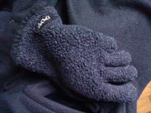 AOG fleece gloves in pocket of Patagonia fleece jacket