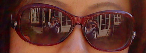 Reflection of Anne Ku in friend's sun glasses in May 2010