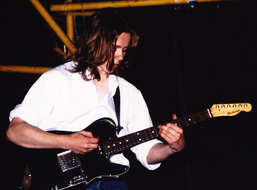 Young man playing electric guitar