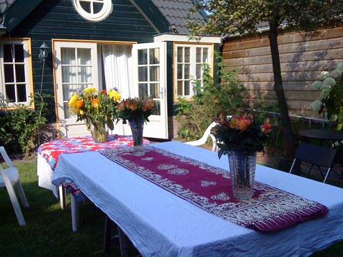 Outdoor tables laid out for an outdoor meal at the Monument House